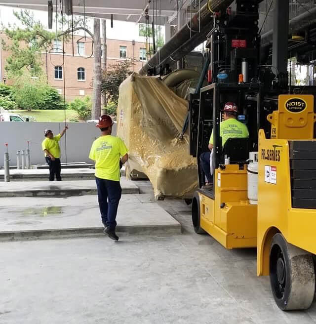 40-60 versalifts with boom attachments and walked chiller onto pads to set into place